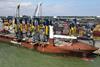 Image shows five new automated electric Rubber-Tyred Gantry cranes have arriving at the Port of Felixstowe by ship