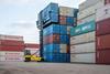 The image shows a Hyster electric container handler stacking boxes