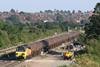 Colas Rail Freight Class 70 811 on a rail track with roofs in the distance
