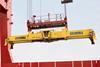 The image shows a Bromma spreader in action on the quayside