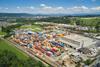 Containers and a large warehouse under a blue sky