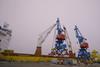 The image shows the Rikon all-electric double jib level luffing cranes on the quayside at the Port of Riga