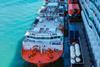 The image shows the bioLNG bunkering operation at Barcelona between the barge Haugesund Knutsen and the cruise ship Mein Schiff Relax
