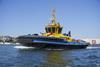 The picture shows a SAAM electric tug on the water