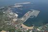 The image shows an aerial shot of the Port of Gijón