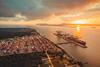 The photo shows a sunset drenched overhead shot of Porto Itapoá in Brazil
