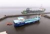 The image shows Lithuania's first electric/green hydrogen powered port tanker