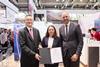 The image shows Hamburg’s Senator for Economic Affairs Dr Melanie Leonhard, HPA CCO Friedrich Stuhrmann and ONE’s managing director, Takahiro Kikuchi, signing the agreement at agreement was formalised at the Transport Logistic 2025 trade fair