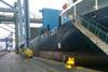 The image shows a ship berthed at the docks during a stopover
