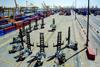 The image shows multiple Konecranes lift trucks on the quayside