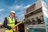 The image shows an high-vis engineer in front of the shore power facilities at Aberdeen