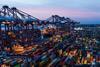 Containers at the Port of Felixstowe with ship-to-shore cranes on the left and two ships just visible