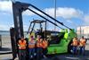 The image shows the San Diego battery electric forklift with the crew posing in front