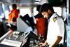 A ship's officer looks at bridge equipment