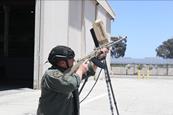 Man with rifle pointing it at the sky looking for pretend drones