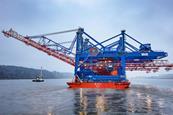 The image shows the new Liebherr cranes being delivered into HHLA CTA