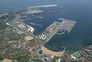 The image shows an aerial shot of the Port of Gijón