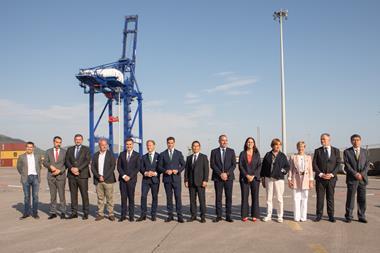 ship-to-shore crane at the Port of BIlbao with port authority and company employees standing in front