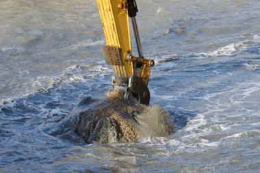 A picture of a grab picking up dredged sediments