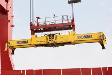 The image shows a Bromma spreader in action on the quayside