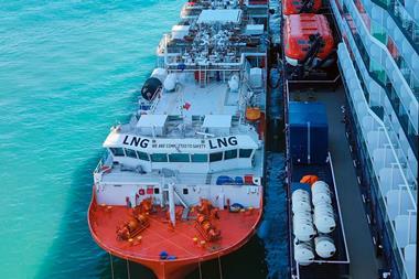 The image shows the bioLNG bunkering operation at Barcelona between the barge Haugesund Knutsen and the cruise ship Mein Schiff Relax