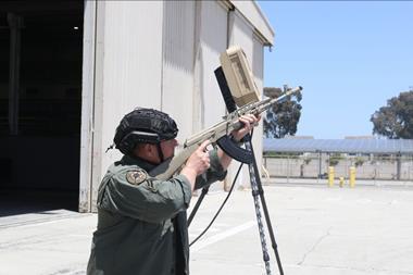 Man with rifle pointing it at the sky looking for pretend drones