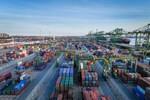 The image shows an overall view of container handling at the Port of Tianjin