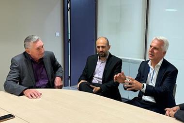 The image shows the GPC 2025 chairs in discussion round a table