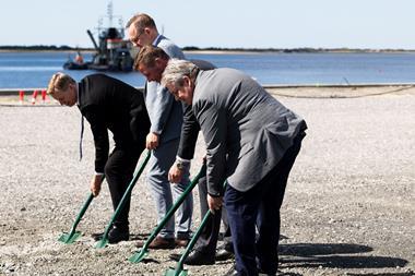 The image shows the Danish Minister for Transport, Thomas Danielsen, with port executives taking shovels to the ground