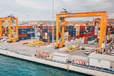 The image shows electric RTGs on the quayside at Slovenia's Port of Koper