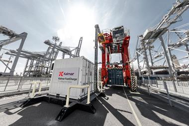 The image shows a Kalmar electric straddle and charging infrastructure