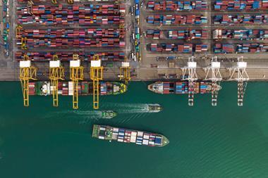 Cargo ship and truck at seaport waiting for container dock by crane shipment