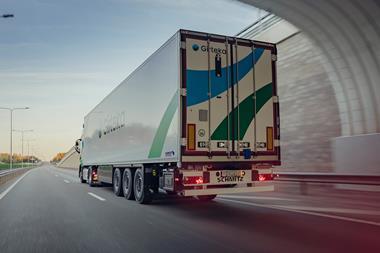 The image shows a Girteka cargo truck on the road