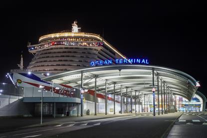 The image shows ABP's Southampton’s iconic Ocean Terminal lit up at night