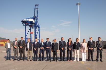 ship-to-shore crane at the Port of BIlbao with port authority and company employees standing in front