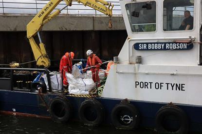 A  view of the pellets being collected and loaded onboard port vessels