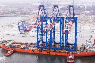 Three ship-to-shore cranes on board a ZPMC carrier arriving at the Baltic Hub in Gdansk