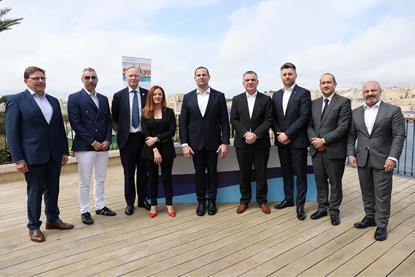 The image shows a crowd of signatories to the shore power agreement including Robert Abela, PM of Malta and representatives from Valletta Cruise Port and Global Ports Holdings, Transport Malta and Carnival Corps