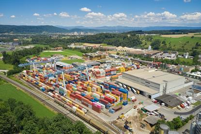Containers and a large warehouse under a blue sky