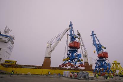 The image shows the Rikon all-electric double jib level luffing cranes on the quayside at the Port of Riga