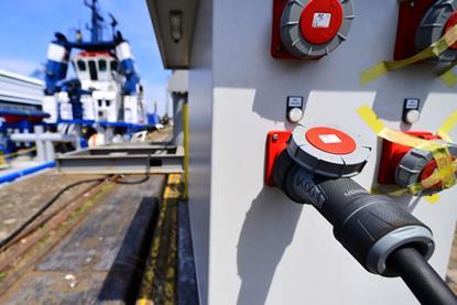 The image shows a ship on shore power