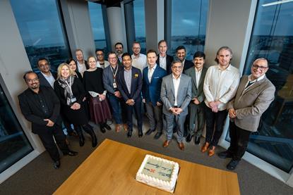 Employees of Kalmar and TCS celebrating a new deal to upgrade IT services