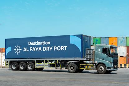 The image shows a truck serving the Al Faya Dry Port Facility