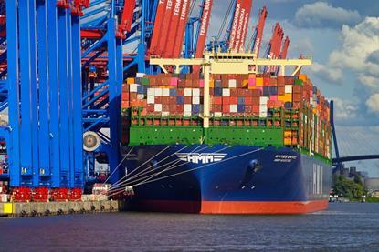 The image shows a Hamburg container terminal with a ship on the quayside