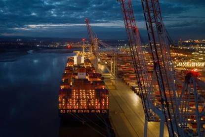 A lit-up ship pictured at the quayside at night