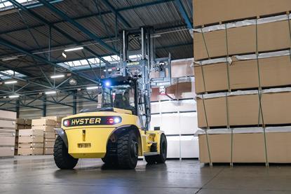 The image shows a Hyster J10-18XD in operation at a warehouse