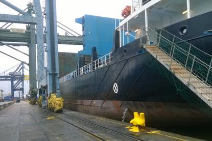 The image shows a ship berthed at the docks during a stopover