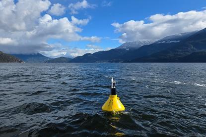 The image shows a MarineLabs buoy on the ocean surface