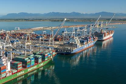 Three container ships at dock in Deltaport, Canada with cranes shoreside