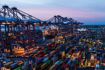 Containers at the Port of Felixstowe with ship-to-shore cranes on the left and two ships just visible